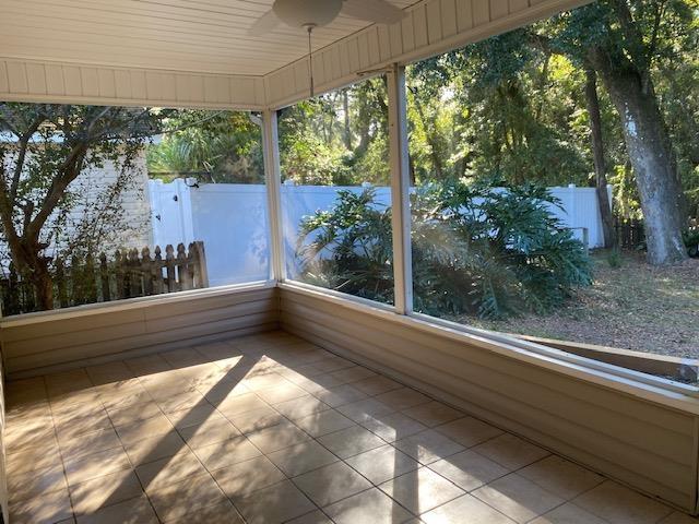 unfurnished sunroom featuring plenty of natural light and ceiling fan