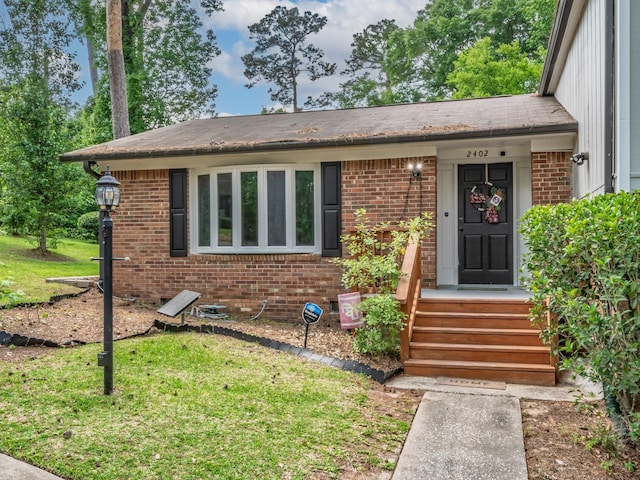 2402 Mexia Ave, Tallahassee, FL 32304 - view of front of property featuring a front lawn and brick siding