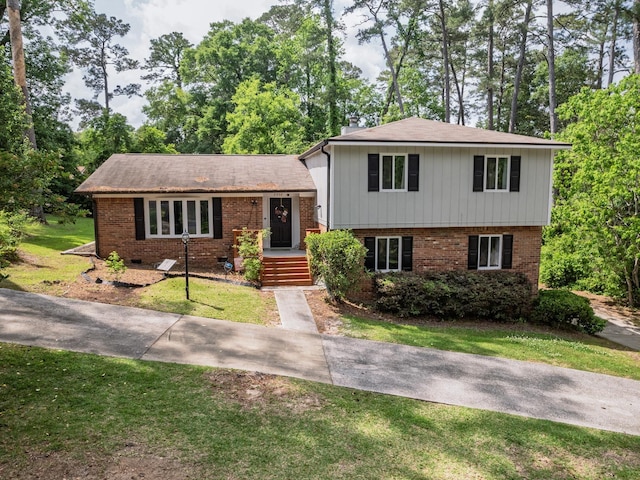 2402 Mexia Ave, Tallahassee, FL 32304 - tri-level home with a front lawn and brick siding
