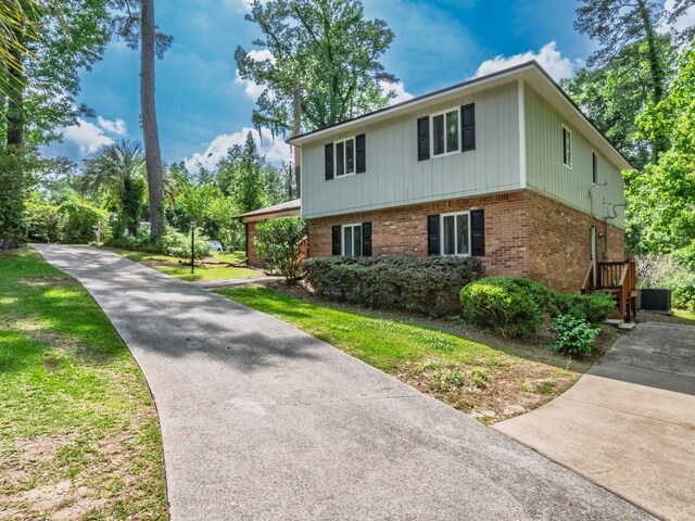 2402 Mexia Ave, Tallahassee, FL 32304 - view of home's exterior featuring driveway, central AC unit, and brick siding