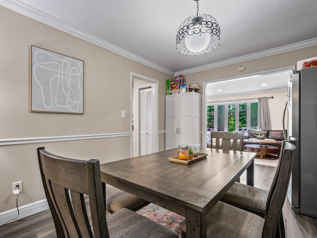 2402 Mexia Ave, Tallahassee, FL 32304 - dining area with baseboards, wood finished floors, and crown molding