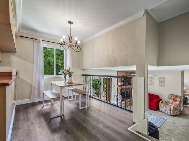 2402 Mexia Ave, Tallahassee, FL 32304 - dining room with wood finished floors, crown molding, a chandelier, and a brick fireplace