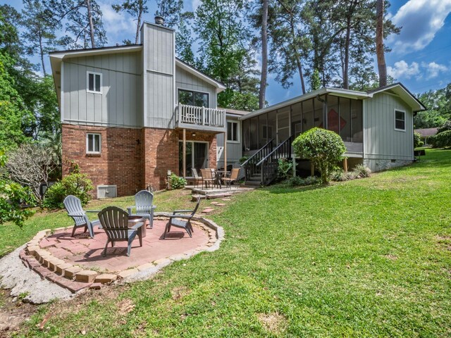 2402 Mexia Ave, Tallahassee, FL 32304 - rear view of property featuring a chimney, brick siding, stairway, a sunroom, and a patio area