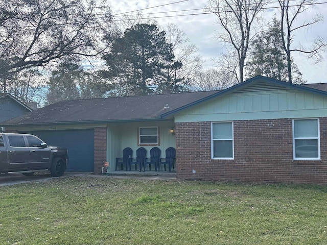 ranch-style house with a garage, a front yard, and brick siding