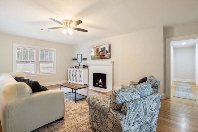 living room featuring hardwood / wood-style flooring and ceiling fan