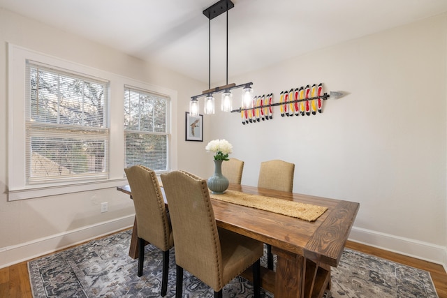 dining area with dark wood-type flooring