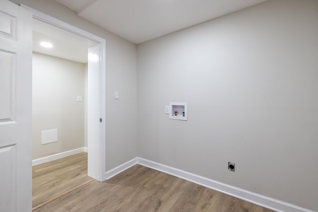 washroom featuring washer hookup, light hardwood / wood-style floors, and electric dryer hookup