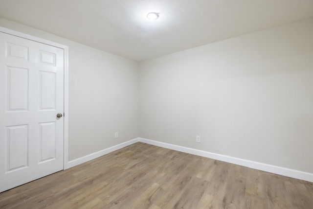 empty room with light hardwood / wood-style flooring