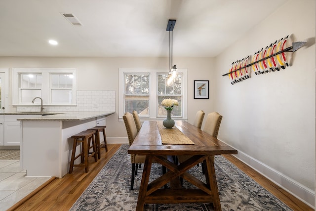 dining area with sink and light hardwood / wood-style flooring