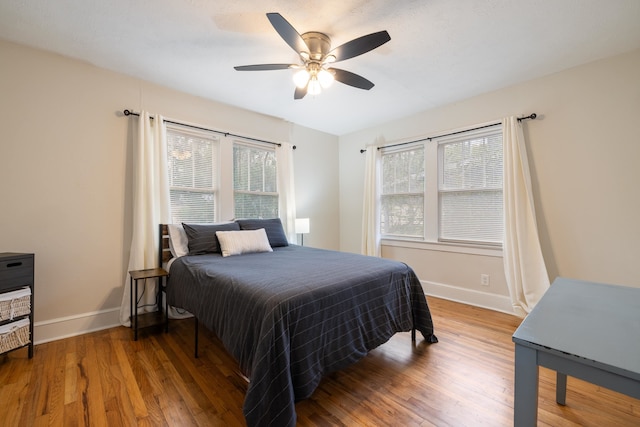 bedroom with wood-type flooring and ceiling fan