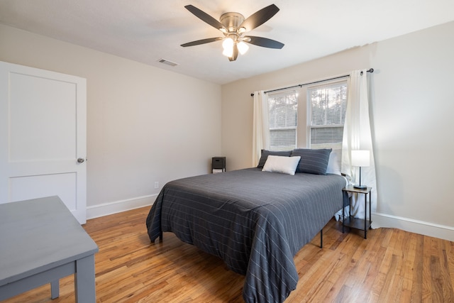 bedroom with light hardwood / wood-style floors and ceiling fan