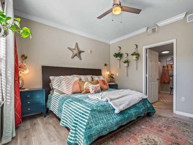 bedroom with crown molding, ceiling fan, and light hardwood / wood-style floors