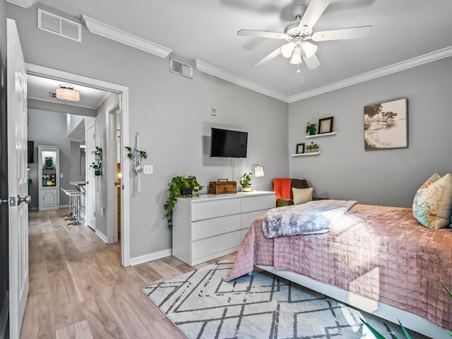 bedroom featuring ornamental molding, ceiling fan, and light hardwood / wood-style flooring