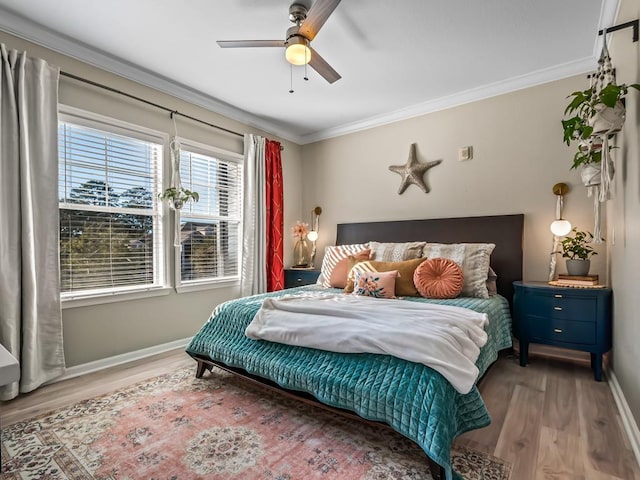 bedroom with ornamental molding, hardwood / wood-style floors, and ceiling fan