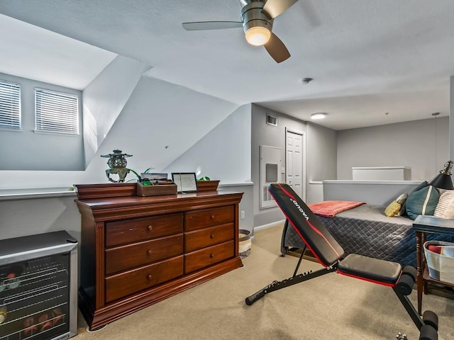 bedroom with lofted ceiling, light colored carpet, a closet, and ceiling fan