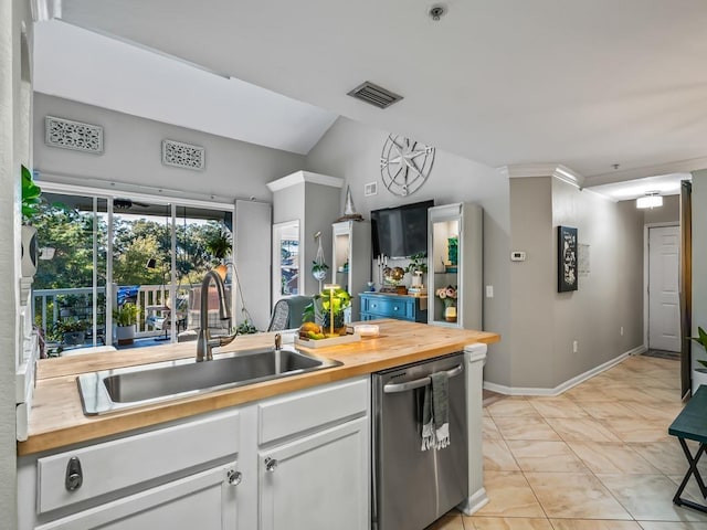 kitchen with dishwasher, sink, white cabinets, wooden counters, and light tile patterned floors