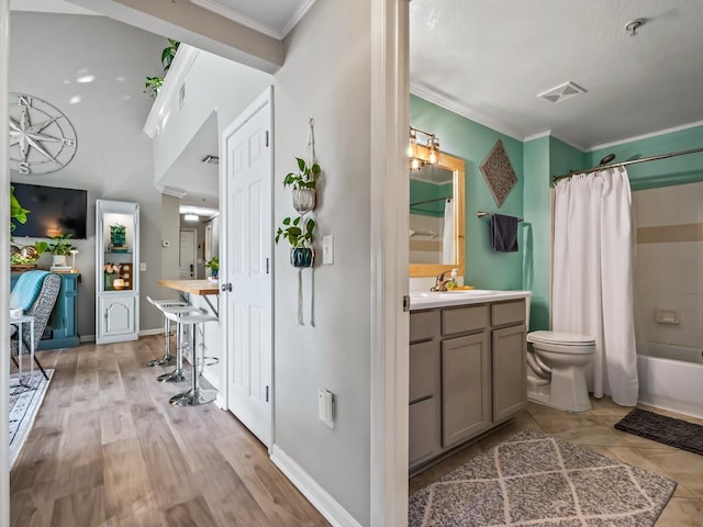 full bathroom with hardwood / wood-style flooring, vanity, shower / tub combo, toilet, and crown molding