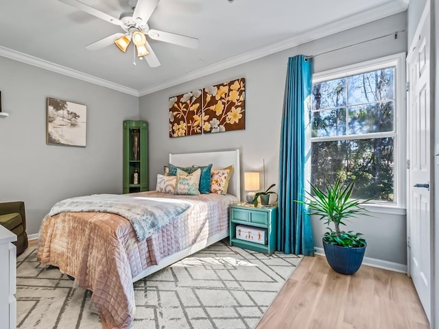 bedroom with ornamental molding, light hardwood / wood-style floors, and ceiling fan