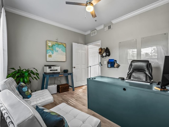 home office with crown molding, ceiling fan, and hardwood / wood-style flooring