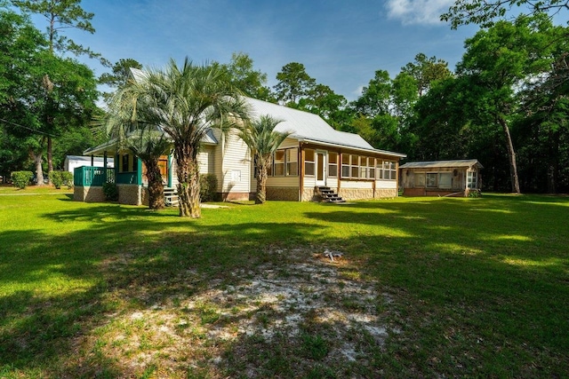 131 Alma Yates St, Quincy, FL 32351 - back of house with a sunroom and a lawn
