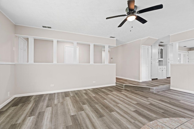 131 Alma Yates St, Quincy, FL 32351 - unfurnished living room with wood finished floors, a ceiling fan, baseboards, and a textured ceiling