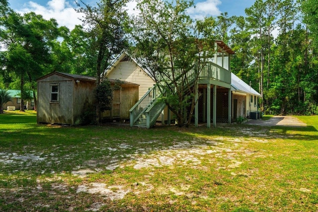 131 Alma Yates St, Quincy, FL 32351 - rear view of house featuring stairway, central AC unit, a yard, and a wooden deck