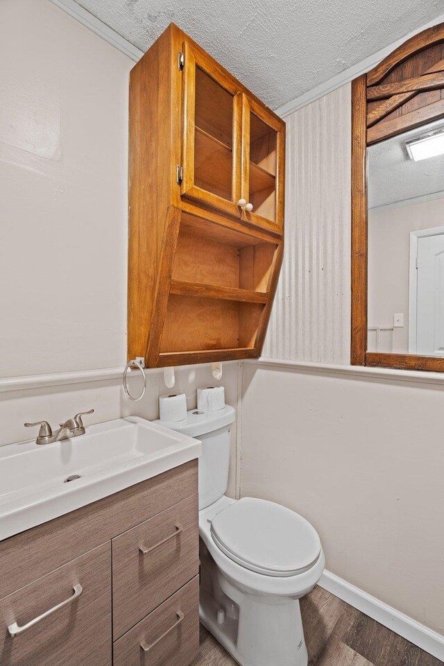 131 Alma Yates St, Quincy, FL 32351 - half bath with toilet, vanity, wood finished floors, a textured ceiling, and baseboards