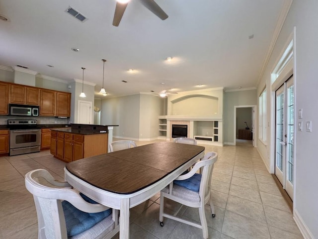 5672 Burnside Cir, Tallahassee, FL 32312 - dining space with a ceiling fan, ornamental molding, light tile patterned floors, and a fireplace