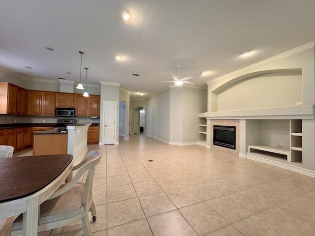 5672 Burnside Cir, Tallahassee, FL 32312 - kitchen featuring appliances with stainless steel finishes, crown molding, built in features, a ceiling fan, and arched walkways