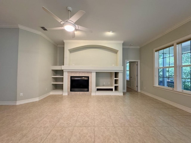 5672 Burnside Cir, Tallahassee, FL 32312 - unfurnished living room with crown molding, a tiled fireplace, built in shelves, a ceiling fan, and light tile patterned flooring