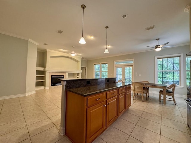 5672 Burnside Cir, Tallahassee, FL 32312 - kitchen featuring ceiling fan, light tile patterned flooring, brown cabinets, ornamental molding, and french doors