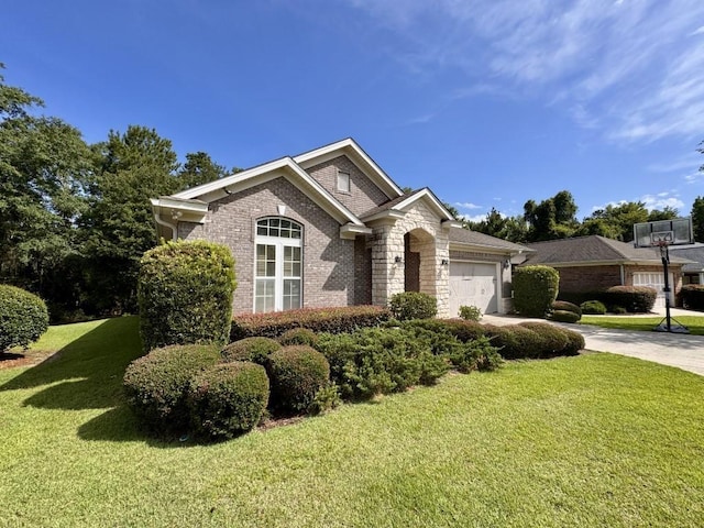 5672 Burnside Cir, Tallahassee, FL 32312 - view of front facade featuring an attached garage, a front yard, brick siding, and driveway