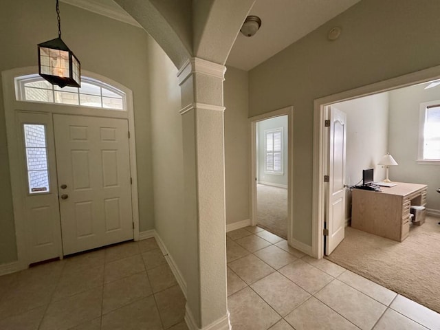 5672 Burnside Cir, Tallahassee, FL 32312 - foyer entrance with light tile patterned flooring, decorative columns, light colored carpet, and arched walkways
