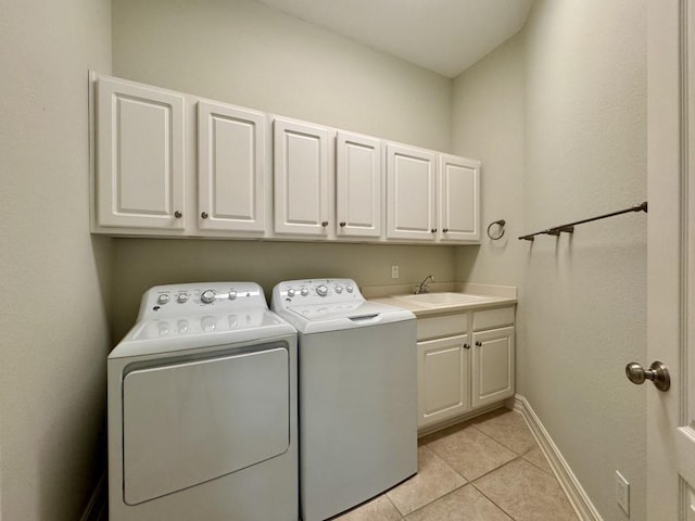 5672 Burnside Cir, Tallahassee, FL 32312 - washroom with cabinet space, washing machine and clothes dryer, and light tile patterned floors
