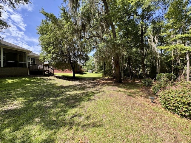 5672 Burnside Cir, Tallahassee, FL 32312 - view of grassy yard with a wooden deck