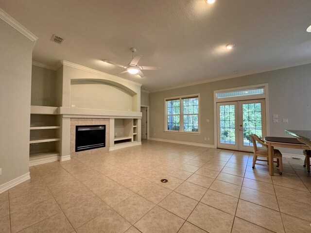 5672 Burnside Cir, Tallahassee, FL 32312 - unfurnished living room featuring ornamental molding, light tile patterned flooring, built in shelves, french doors, and a ceiling fan