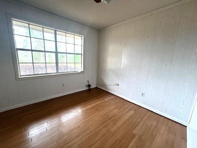 unfurnished room with ceiling fan, ornamental molding, and dark hardwood / wood-style floors