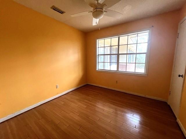 unfurnished room featuring hardwood / wood-style flooring and ceiling fan