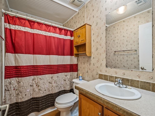 bathroom with vanity, walk in shower, a textured ceiling, and toilet