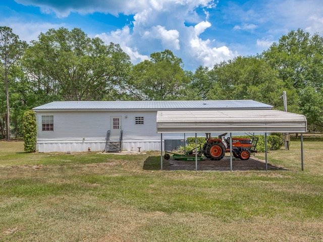 view of outbuilding with a yard and a carport