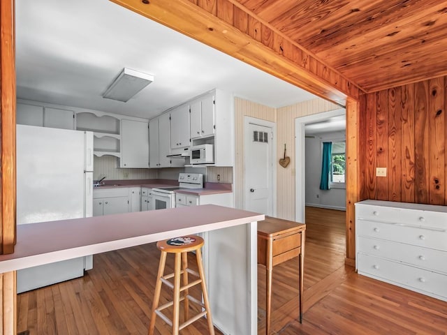 kitchen featuring white cabinetry, sink, white appliances, and light wood-type flooring