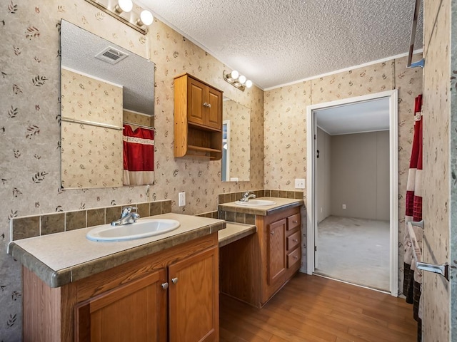 bathroom with hardwood / wood-style flooring, vanity, a textured ceiling, and a shower with shower curtain