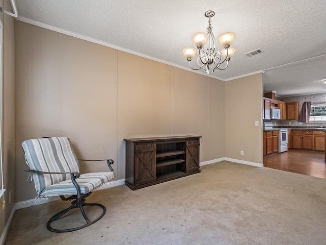 sitting room with a notable chandelier, crown molding, a textured ceiling, and carpet flooring