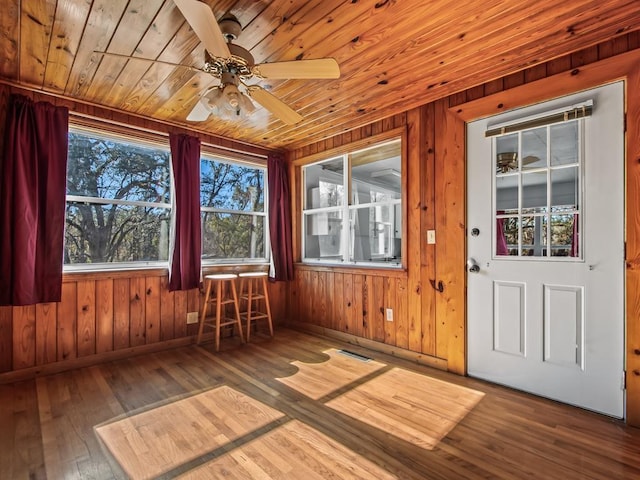 unfurnished sunroom featuring wooden ceiling and ceiling fan