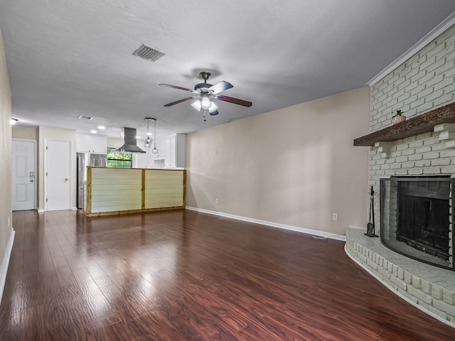 2600 Panther Creek Rd Unit A, Tallahassee, FL 32308 - unfurnished living room featuring a ceiling fan, a fireplace, and dark wood-type flooring