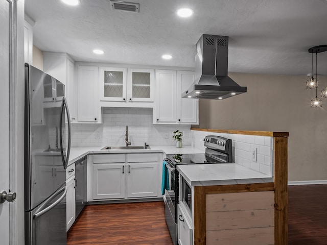 2600 Panther Creek Rd Unit A, Tallahassee, FL 32308 - kitchen featuring appliances with stainless steel finishes, island exhaust hood, dark wood finished floors, backsplash, and white cabinetry