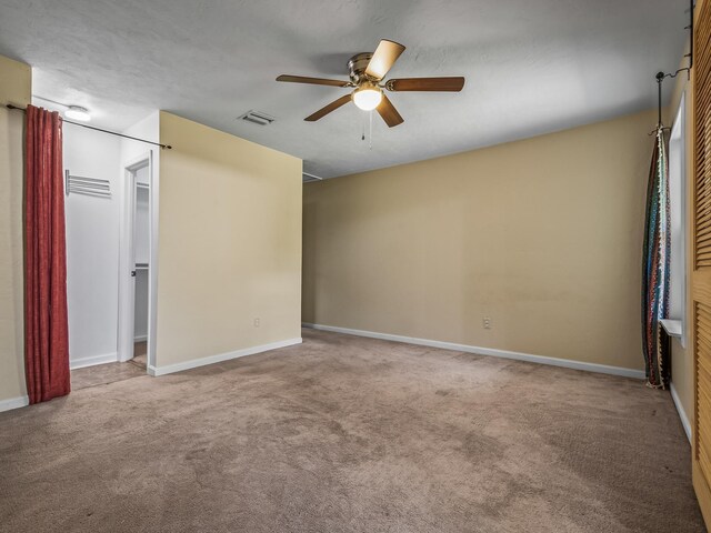 2600 Panther Creek Rd Unit A, Tallahassee, FL 32308 - unfurnished bedroom with carpet floors, a ceiling fan, and a walk in closet