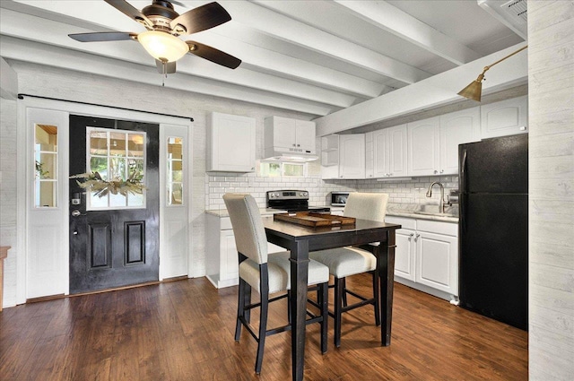 1645 Tallavana Trl, Havana, FL 32333 - kitchen with stainless steel appliances, a sink, beam ceiling, white cabinets, and tasteful backsplash