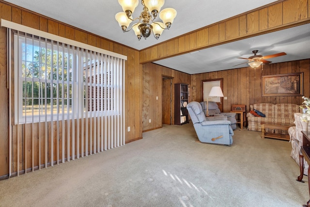 living room with light carpet, a healthy amount of sunlight, and ceiling fan with notable chandelier