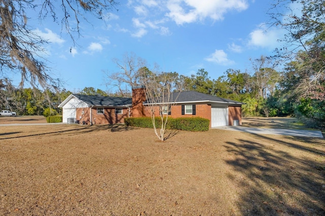 ranch-style house featuring a garage and a front yard